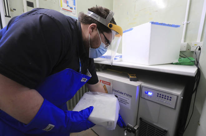 A pharmacy technician from Croydon Health Services prepares to store the first delivery of COVID-19 vaccine