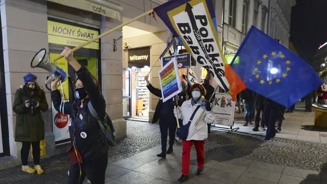 Protesters carry an EU flag at an anti-government protest in Warsaw