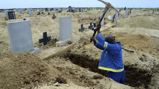 A grave digger prepares graves in Port Elizabeth amid a second wave of coronavirus in South Africa