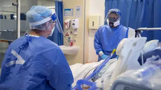 NHS staff tend to a Covid patient on an intensive care ward in Merseyside.
