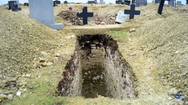 A freshly-dug grave sits at the Motherwell Cemetery in Port Elizabeth, South Africa (Theo Jeftha/AP)