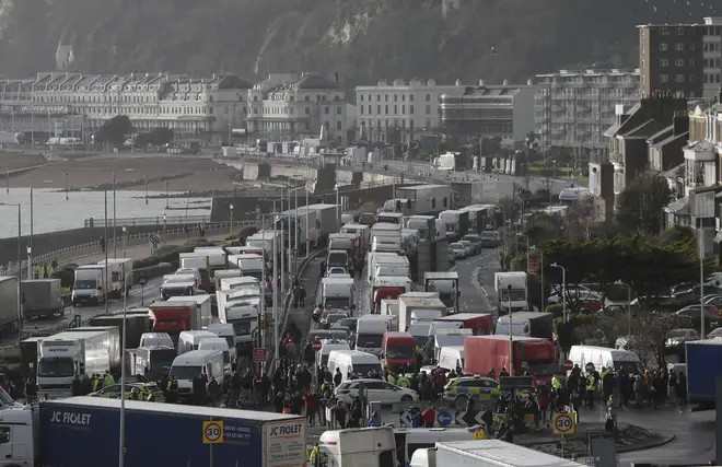 Vehicles wait at the entrance to the Port of Dover, that is blocked by police