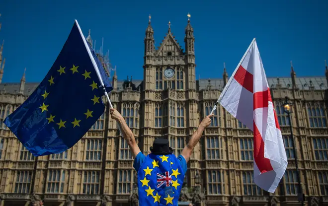 File photo: An anti-Brexit demonstrator holding European Union and England flags outside the Houses of Parliament
