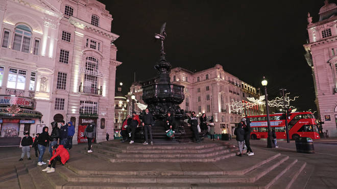 London's Piccadilly Circus was uncharacteristically quiet as the capital ushered in 2021