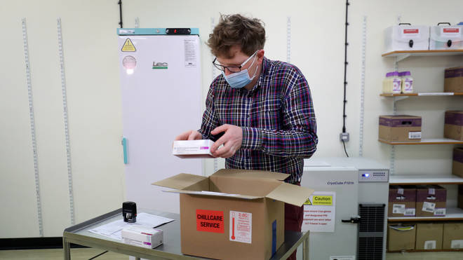 Assistant Technical Officer Lukasz Najdrowski unpacks doses of the Oxford University/AstraZeneca Covid-19 vaccine as they arrive at the Princess Royal Hospital in Haywards Heath