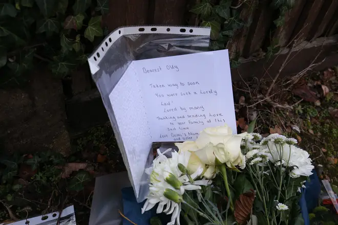 Floral tributes and a card to a boy called Olly left outside Highdown School in Reading
