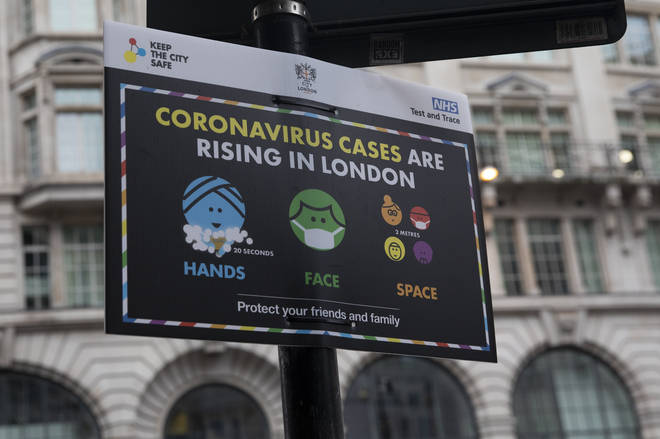 A sign warning of the rising cases of coronavirus in London
