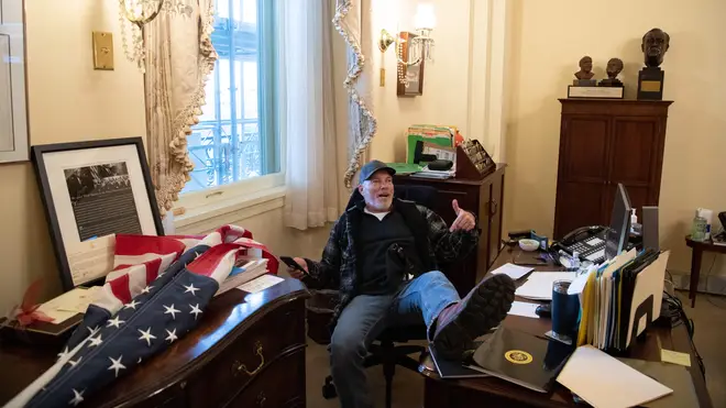 Richard Barnett, a supporter of US President Donald Trump, has been arrested after being pictured with his feet on the desk of Nancy Pelosi