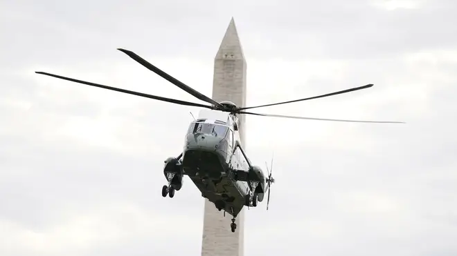 The Washington Monument is seen in the background, as Marine One lands on the South Lawn (Evan Vucci/AP)