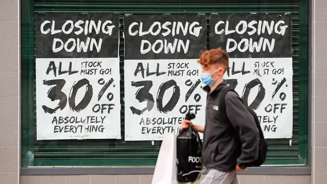 A shop window during a closing down sale