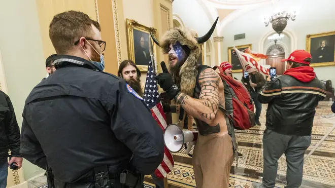 Supporters of President Donald Trump are confronted by US Capitol Police officers outside the Senate Chamber inside the Capitol in Washington