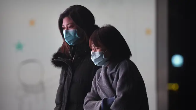 People wearing face masks to protect against the spread of the coronavirus in Beijing