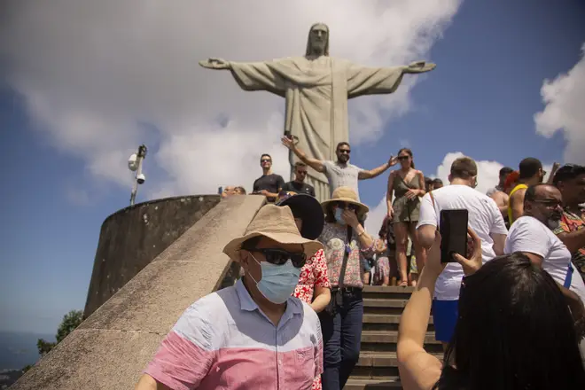 A tourist wears a face mask while visiting Christ the Redeemer