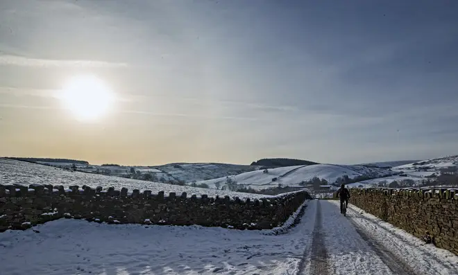A cyclist on the snow at Blackmoss Reservoir in Barley, Pendle, Lancashire
