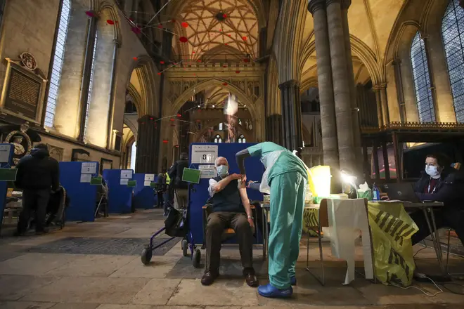 Former RAF Flight Sergeant Louis Godwin receives an injection of the Pfizer coronavirus vaccine at Salisbury Cathedral