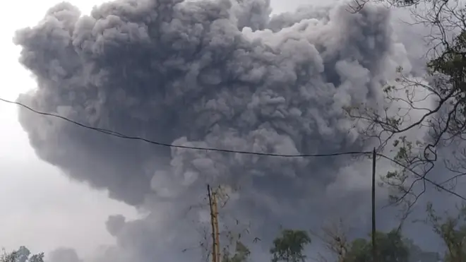 Mount Semeru spews volcanic material during an eruption in Lumajang