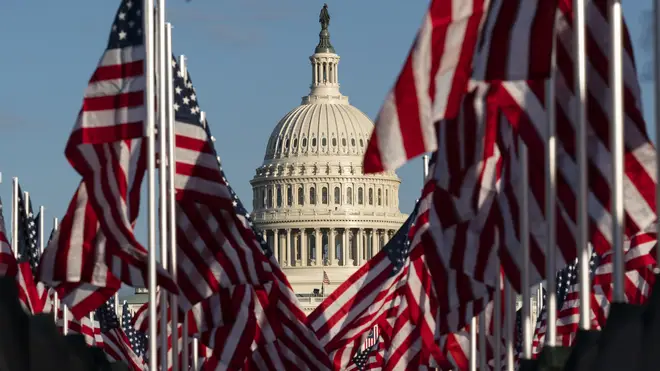 Flags are placed on the National Mall, with the US Capitol behind them, ahead of the inauguration of President-elect Joe Biden and Vice President-elect Kamala Harris (Alex Brandon/AP)