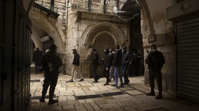 Israeli police watch worshippers leave at the Dome of the Rock Mosque in the Al Aqsa Mosque compound in the Old City of Jerusalem (Maya Alleruzzo/AP)