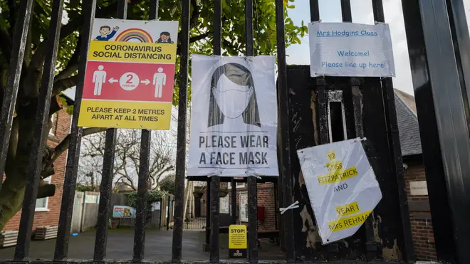 Posters informing on social distancing and face coverings outside Beatrix Potter Primary School in Wandsworth