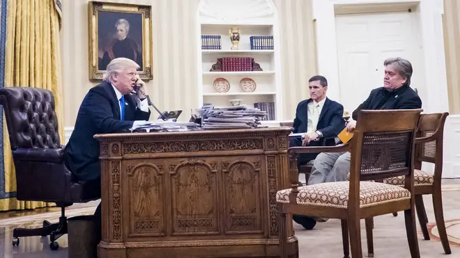 Steve Bannon, sit nearby as President Donald Trump speaks on the phone with Prime Minister of Australia, Malcolm Turnbull in the Oval Office on January 28, 2017
