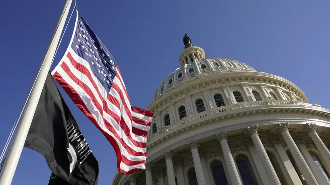 Flags fly on the US Capitol in Washington ahead of the 59th Presidential Inauguration