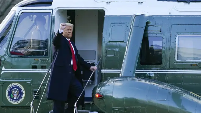 President Donald Trump gestures as he boards Marine One on the South Lawn of the White House