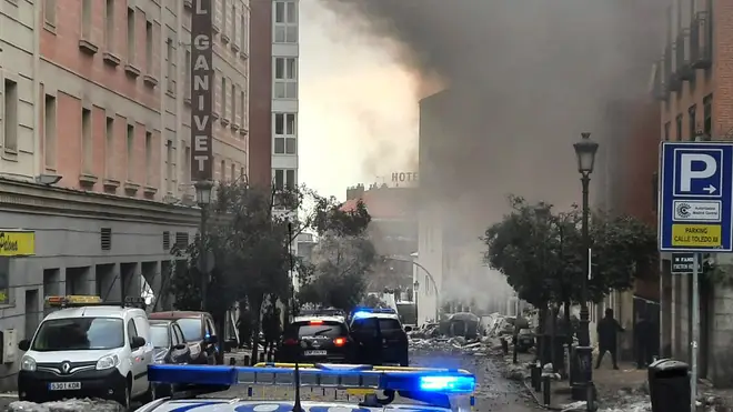 Smoke rises from a building and rubble scattered in Toledo Street following a explosion in Madrid