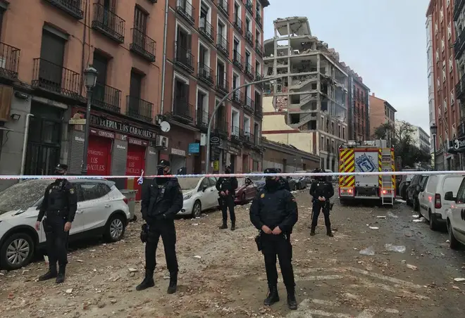 Police officers cordon off Toledo Street following an explosion in downtown Madrid, Spain