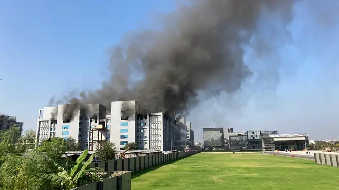 Smoke rises from the Serum Institute of India, the world’s largest vaccine maker that is manufacturing the AstraZeneca/Oxford University vaccine in Pune, India