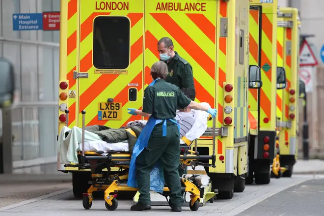 A patient is taken from an ambulance after being transferred to the Royal London Hospital in London