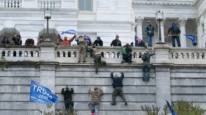 Supporters of President Donald Trump climbed the west wall of the the US Capitol