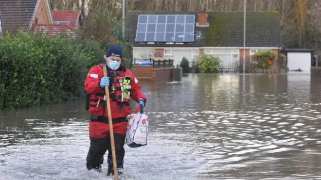 Knutsford firefighter making his way through floodwater to assist with evacuation efforts in and around Cheshire