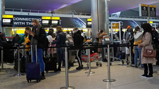 File photo of customers queuing at the check-in desk in Heathrow's Terminal 2 departures hall