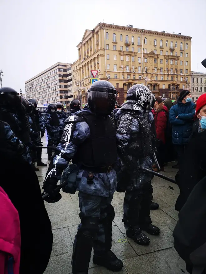 Police covered in what appears to be white paint during one of the protests in Russia