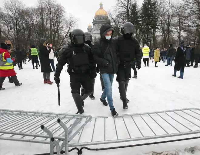 Riot police officers detain a participant in an unauthorized rally in support of Russian opposition activist in Senate Square, St Petersburg.