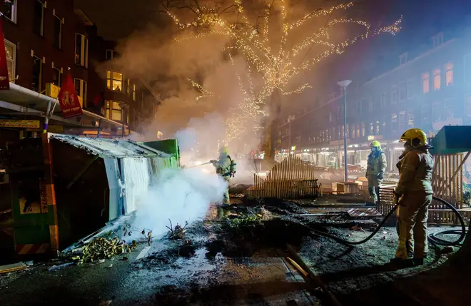 Firefighters work to extinguish a fire on the Groene Hilledijk in Rotterdam
