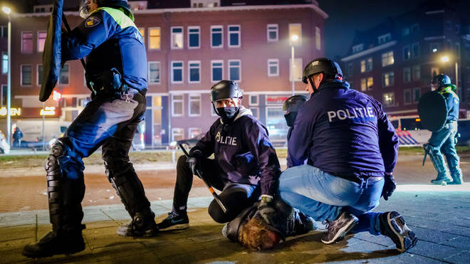 Police detain a protester in the Netherlands during the lockdown unrest