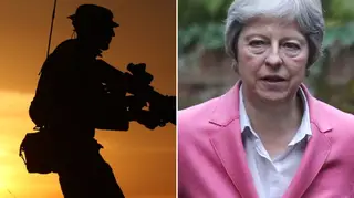 Theresa May faces criticism for being "distracted" during a meeting about soldier mental health