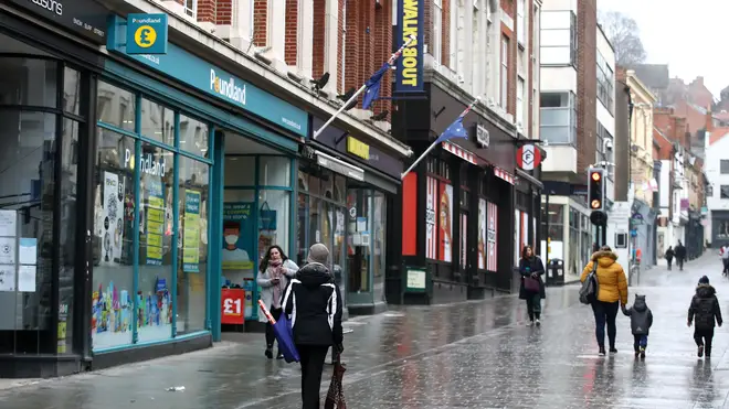 Shoppers walking past closed shops and Poundland in Lincoln city centre