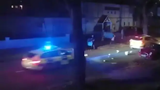 Thugs throw wheelie bins at a passing police car