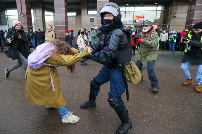 A police officer detains a demonstrator during an unauthorised protest in St Petersburg.