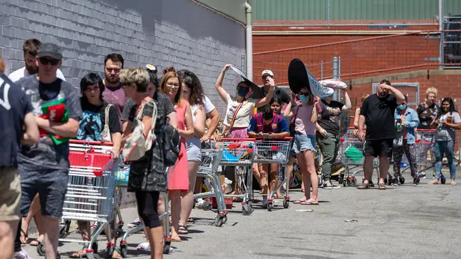 Long queues are seen outside a supermarket in Perth that was designated a potential exposure site