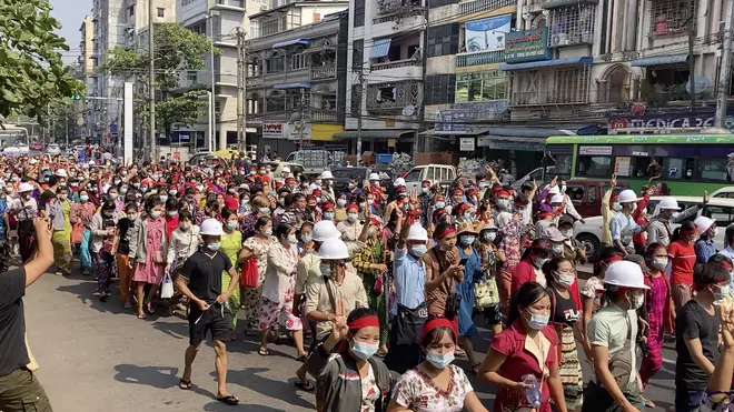 A crowd of protesters march in Yangon, Myanmar