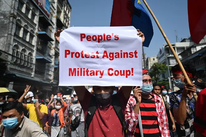 A protester holds up a sign during a demonstration against the military coup in Yangon