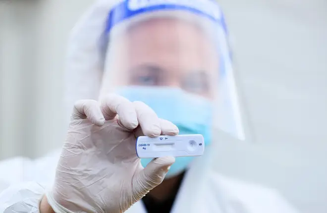 File photo: A lab technician holds a Healgen Covid-19 Rapid Antigen Test at RocDoc's testing facility in Gorey, Co. Wexford
