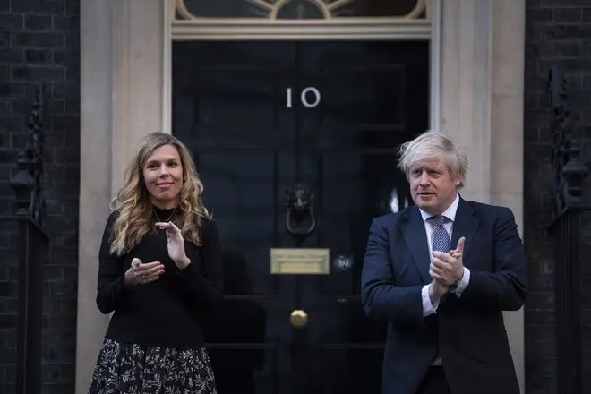 Prime Minister Boris Johnson and Carrie Symonds stand in Downing Street, London, to join in Clap for Carers