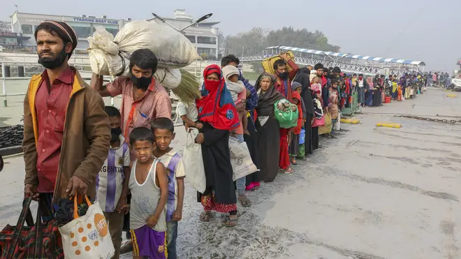 Rohingya refugees headed to the Bhasan Char island prepare to board navy vessels from the south eastern port city of Chattogram, Bangladesh