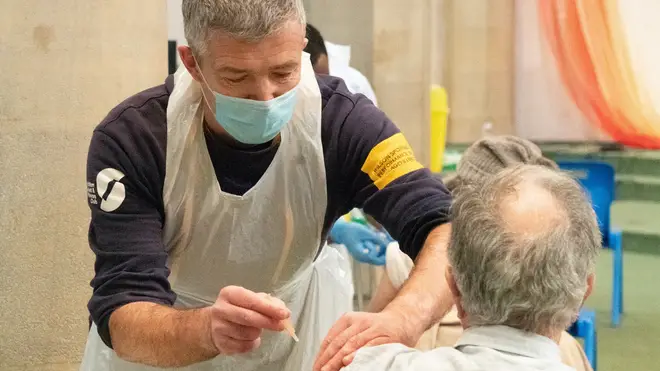 A man receives a covid-19 jab in a vaccination centre in St John's Church in Ealing, London