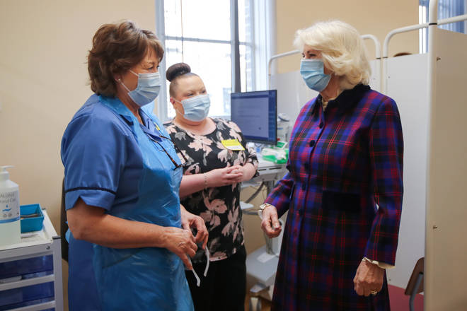Camilla, Duchess of Cornwall, speaks with a member of staff during a visit at Queen Elizabeth Hospital