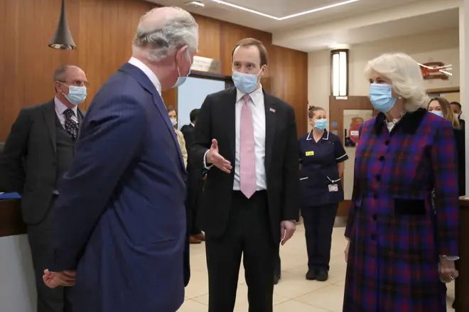 Prince Charles and Camilla, Duchess of Cornwall, talk with Health Secretary Matt Hancock